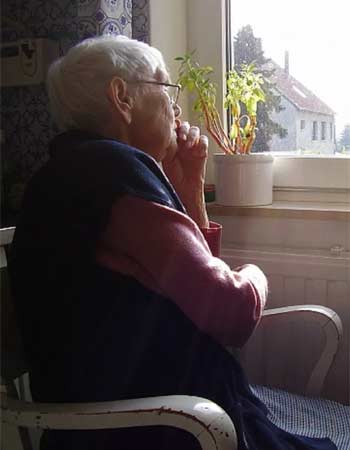 Man sitting in chair looking out the window