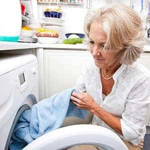 Lady taking a towel out of the dryer